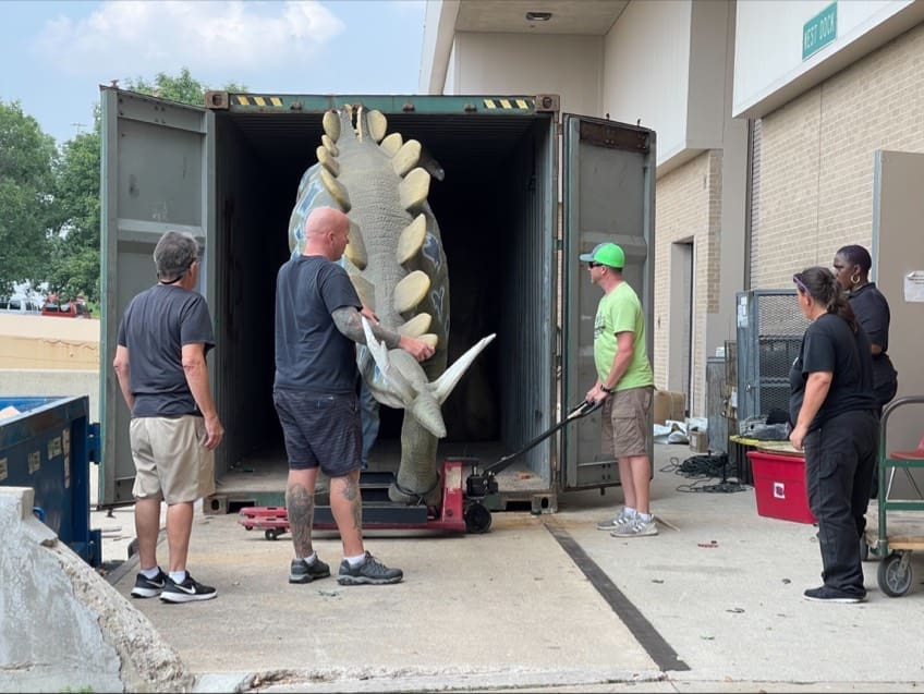 dinosaurs loading in truck